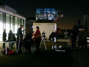 Telescopes all set up with the Ship in a Bottle in the background